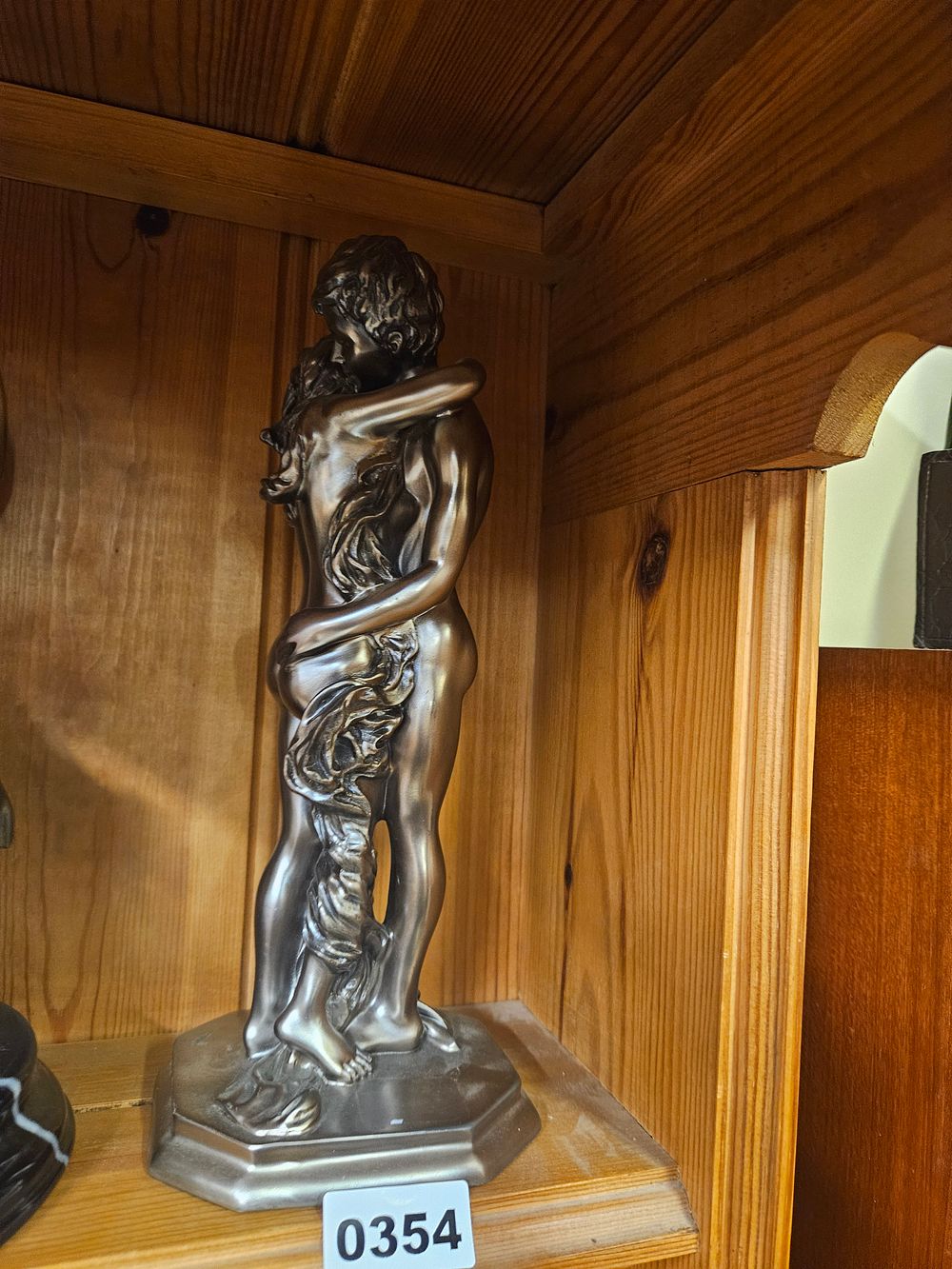Lot 354 – A contemporary bronze-effect sculpture of an embracing couple