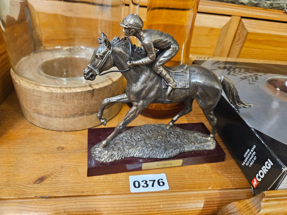 Lot 376 – A silver-toned commemorative horse racing figurine of Shergar on a wood-effect plinth