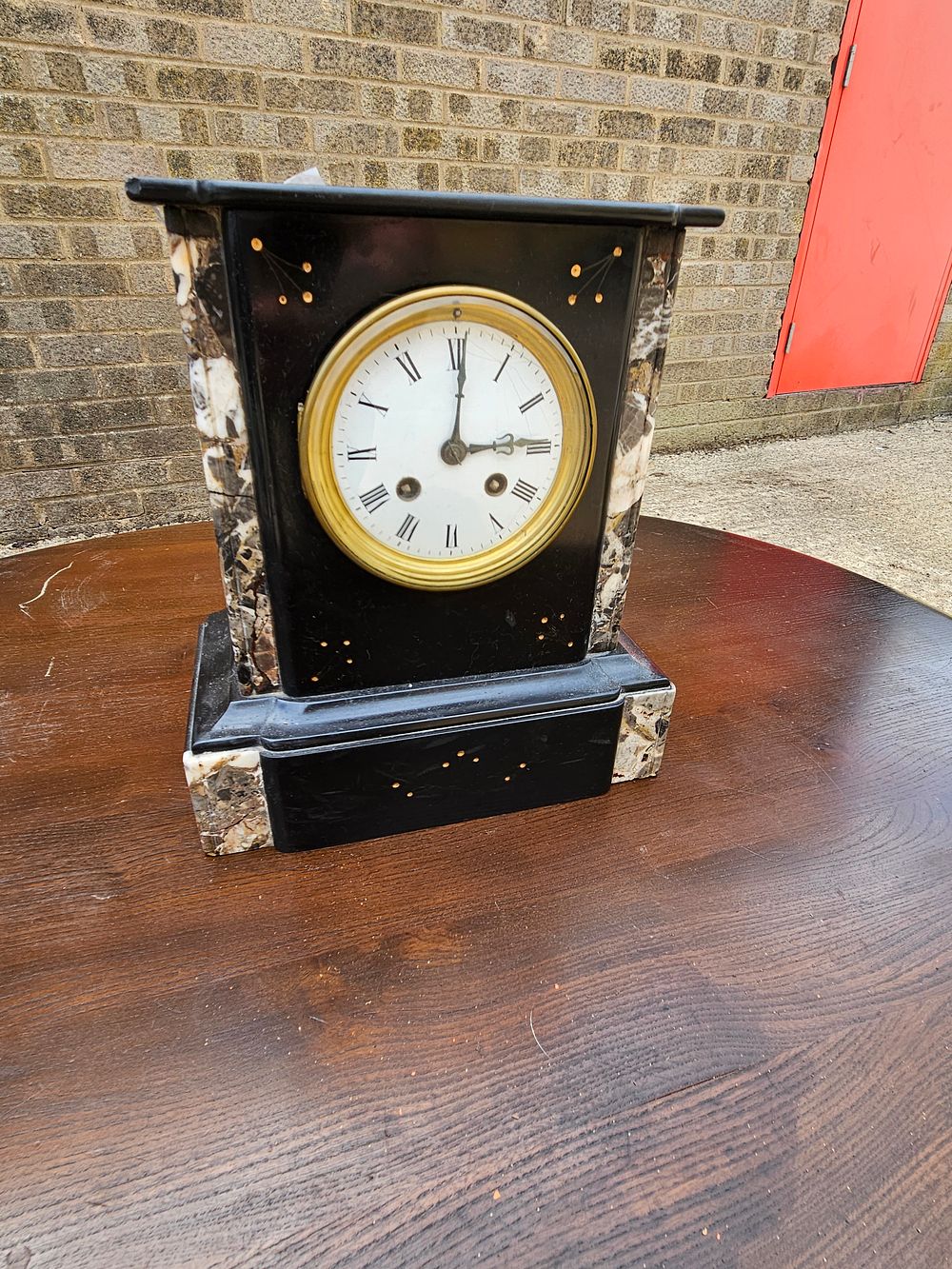 Lot 265 – A Victorian black slate and variegated marble architectural mantel clock