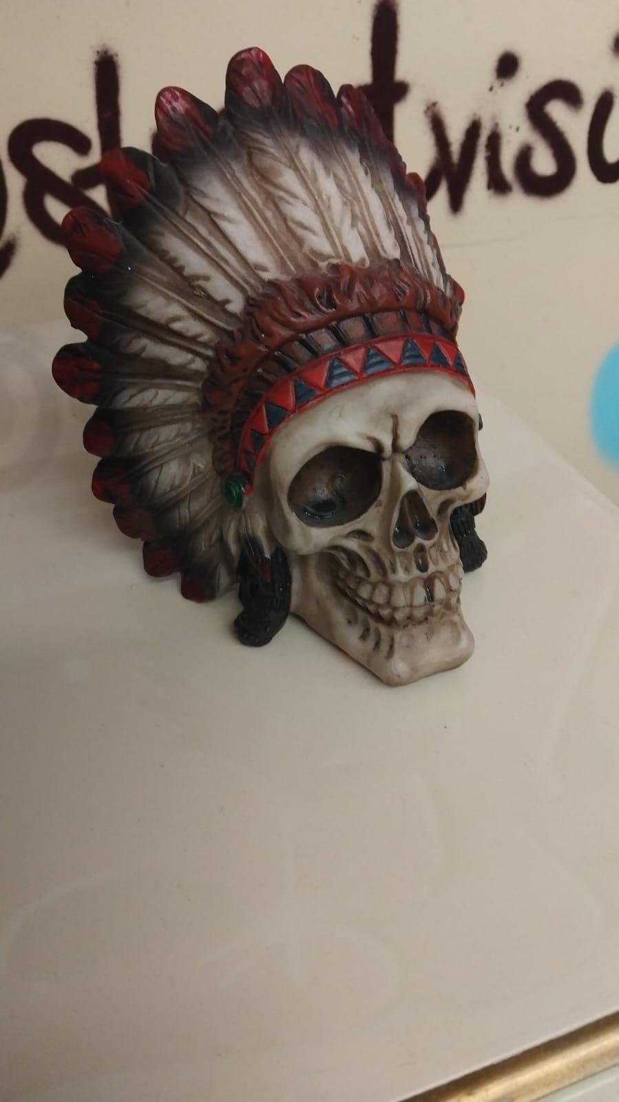 Lot 276 – A Decorative Cast Resin Skull Figurine in a Native American Style Headdress