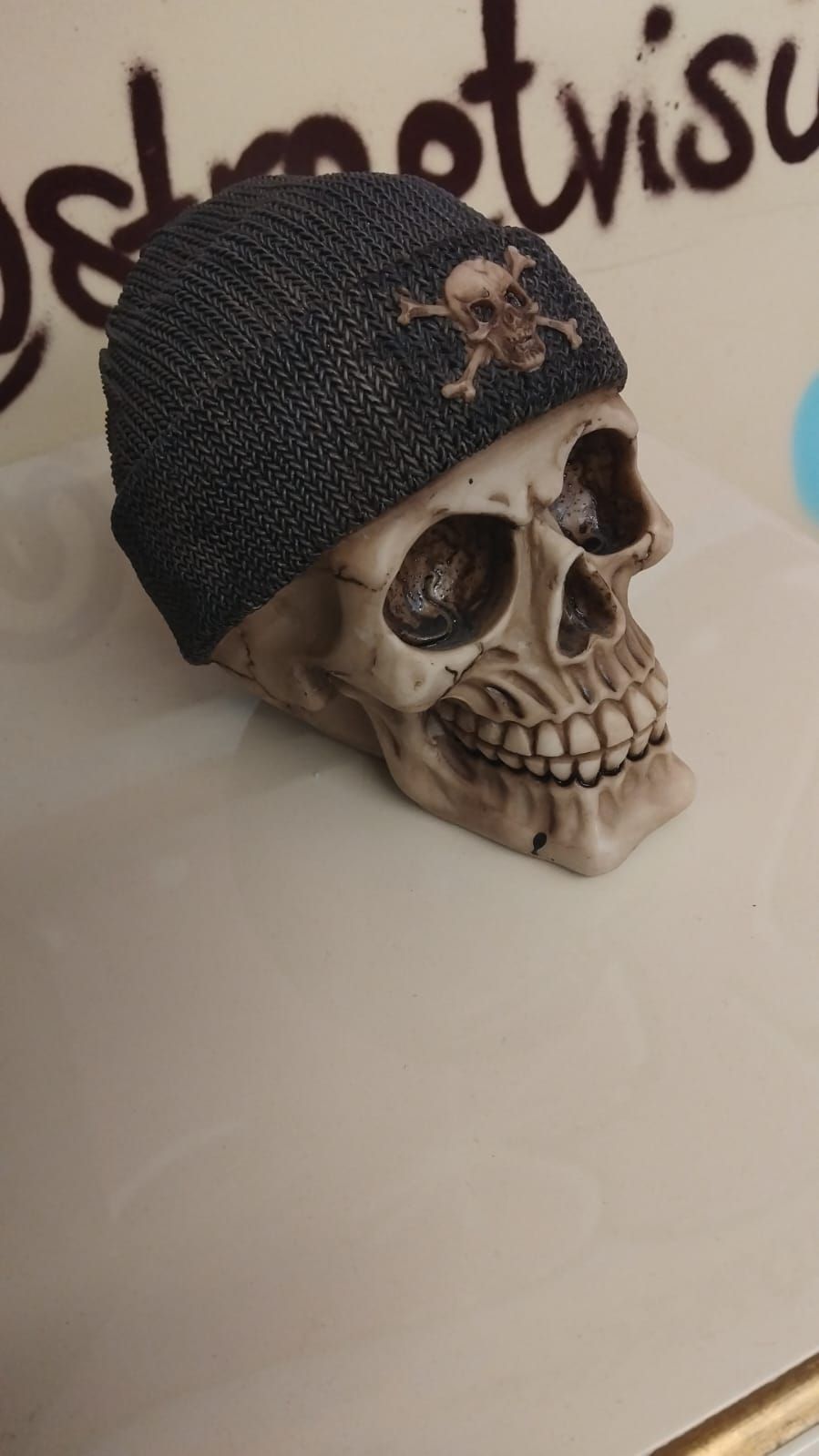 Lot 278 – A Decorative Resin Skull Wearing a Knitted-Style Beanie Hat