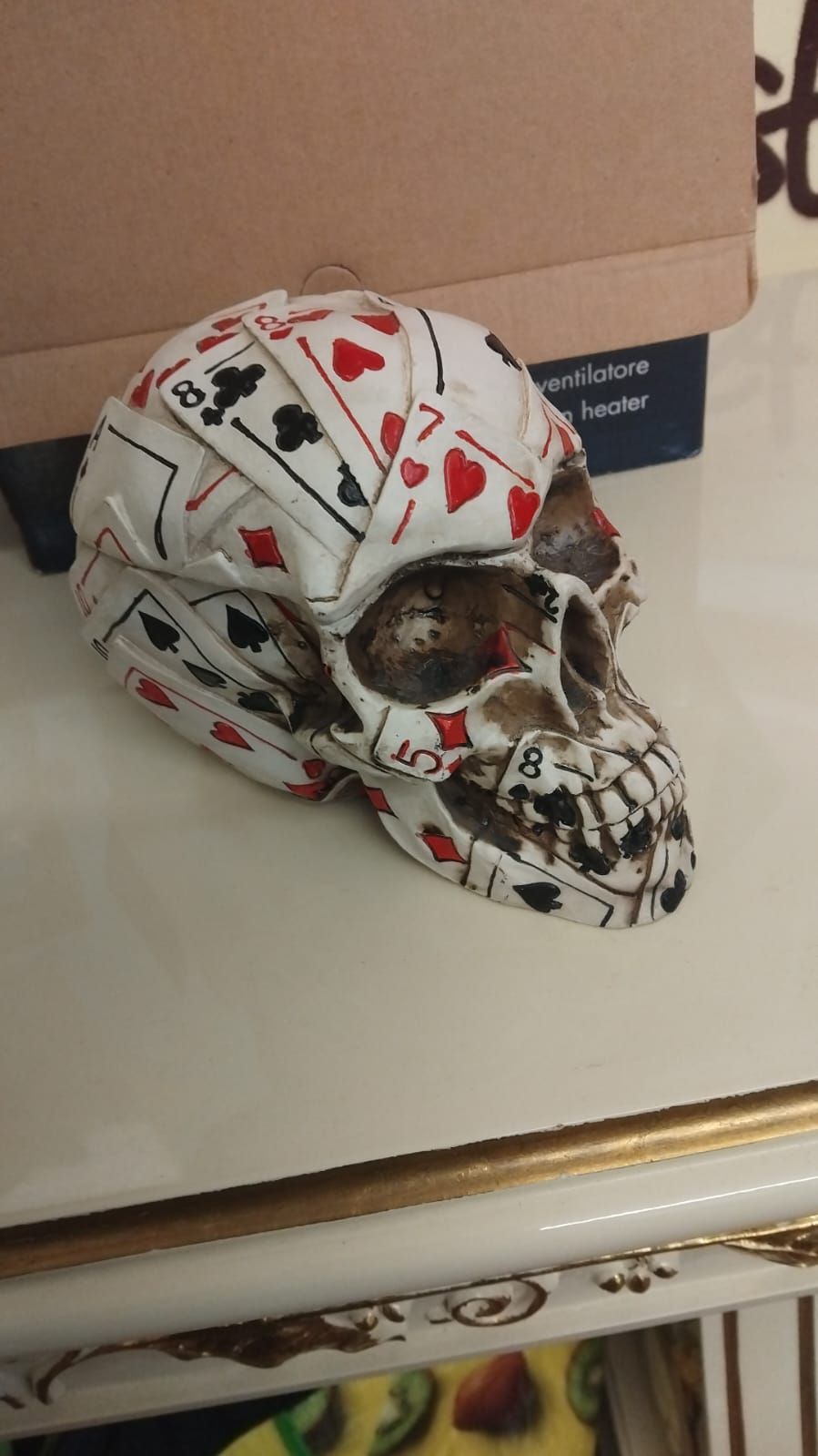 Lot 288 – A Decorative Cast Resin Poker Motif Skull Trinket Box