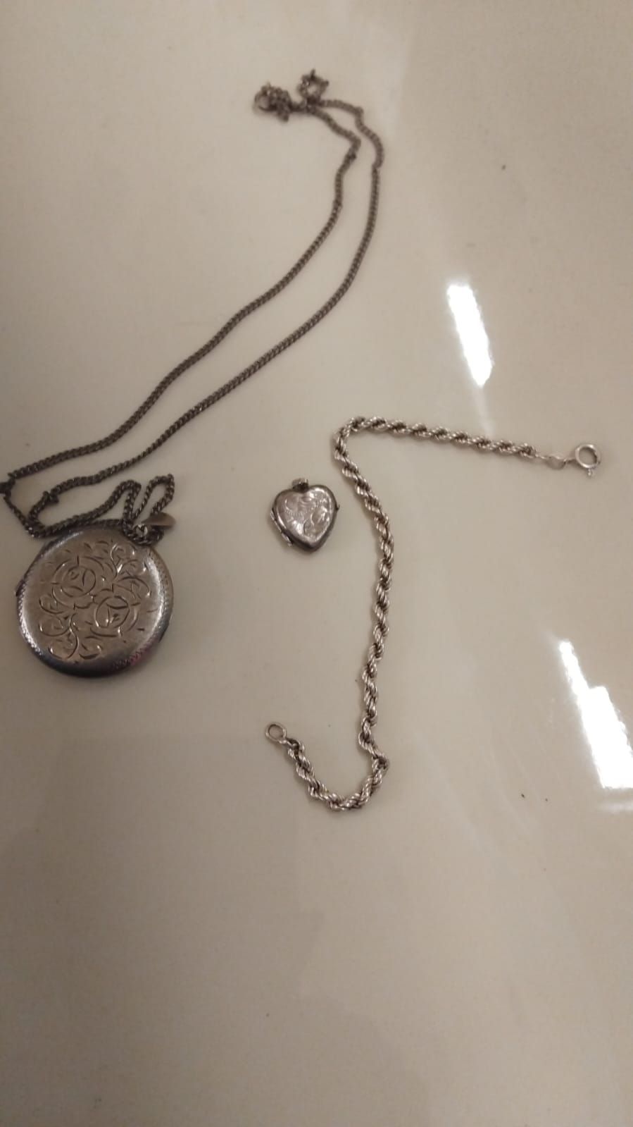 Lot 325 – A Trio of Silver Jewellery Including Two Lockets and a Rope Chain Bracelet
