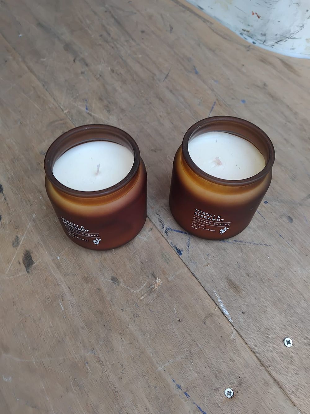Lot 157 – A Pair of Contemporary Neroli and Bergamot Scented Candles in Amber Glass Jars