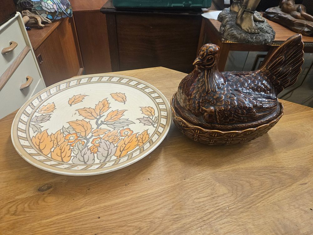 Lot 173 – Two items of ceramic ware comprising a charger Charlotte Rhead and a hen-on-nest covered dish