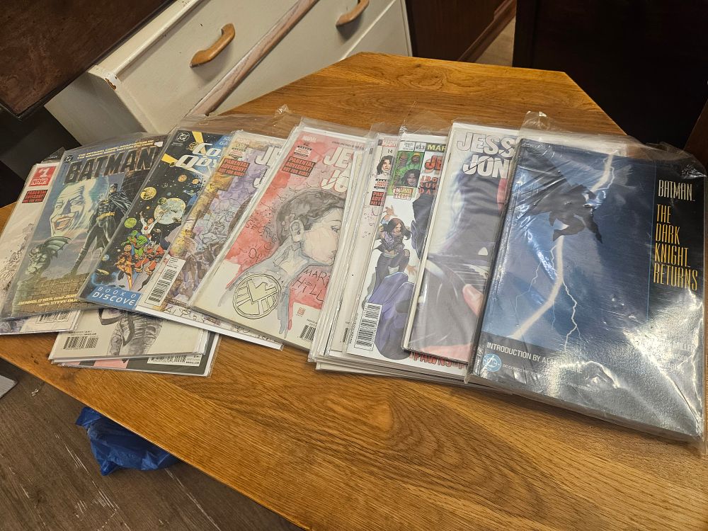 Lot 178 – A Collection of DC and Marvel Comic Books and Graphic Novels Including Batman and Jessica Jones Titles