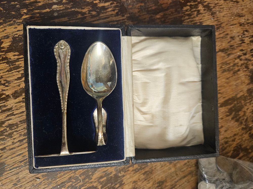 Lot 210 – A Cased Silver-plated Child’s Christening Set comprising a Loop-handled Spoon and a Food Pusher