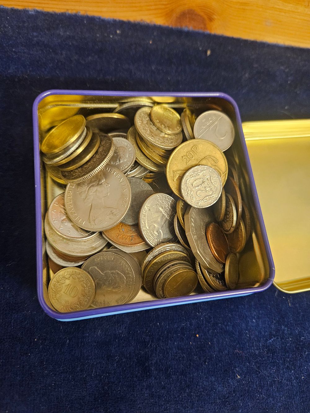 Lot 223 – A Collection of World Coins in a Purple Metal Tin