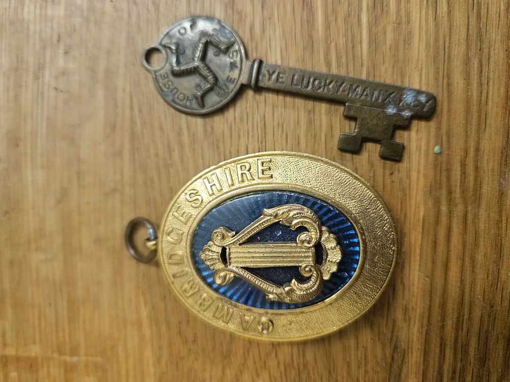 Lot 299 – Two British Commemorative Items comprising an Isle of Man Souvenir Key and a Cambridgeshire Gilt and Enamel Award Medal
