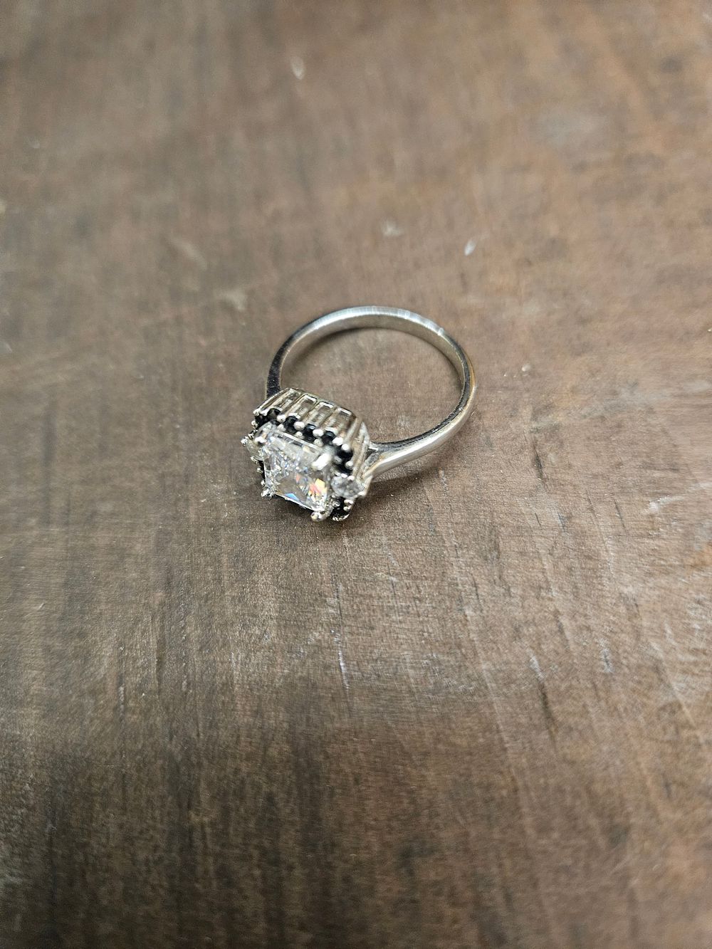 Lot 304 – A 925 Silver Cocktail Ring with Square-Cut Colorless Stone and Black Stone Halo