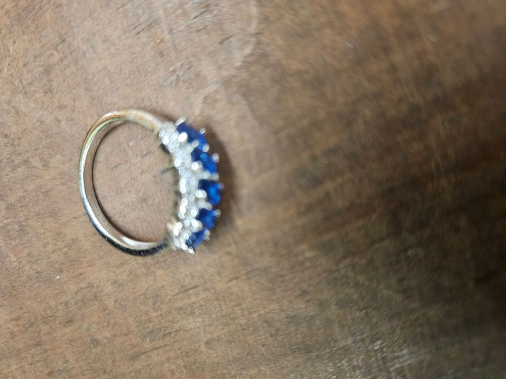 Lot 308 – A Blue Sapphire and Colourless Accent Half-Eternity Style Ring in 925 Silver