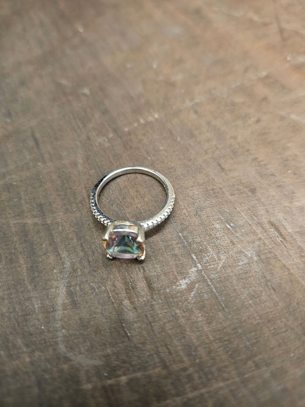 Lot 312 – A 925 Silver Cocktail Ring Set with a Cushion-Cut Iridescent Stone and Pavé-Set Shoulders