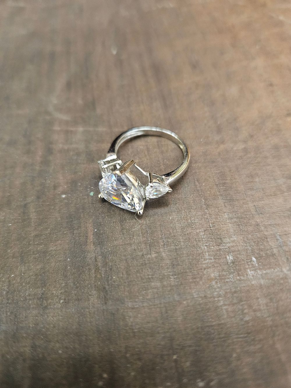 Lot 317 – A 925 silver three-stone trilogy ring set with pear-cut colourless stones