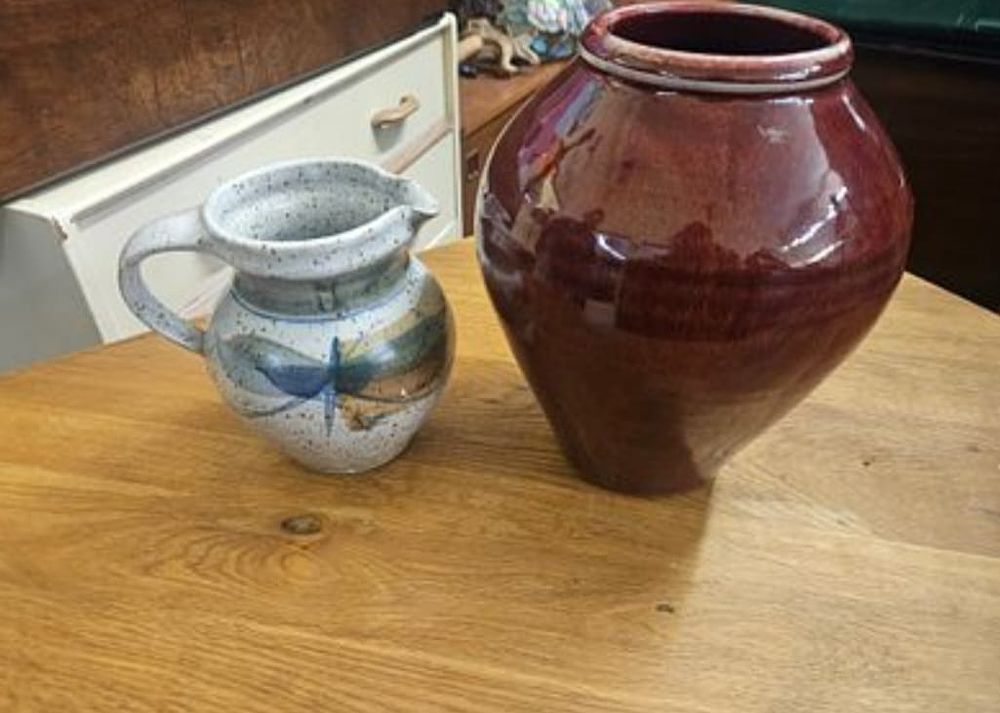 Lot 158 – Two pieces of contemporary studio pottery comprising a dragonfly decorated pitcher and an oxblood glazed vase