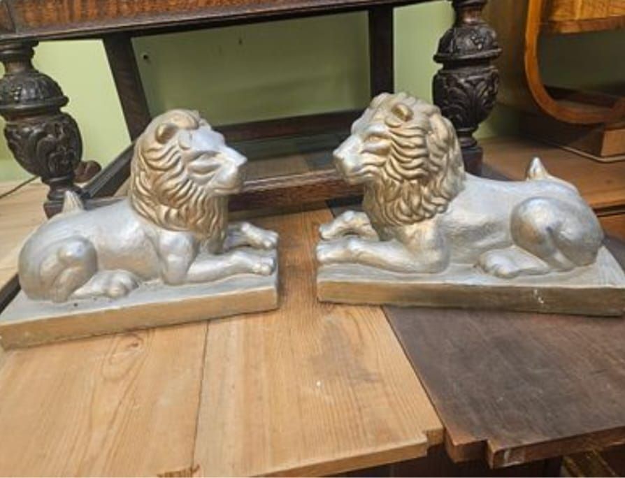 Lot 162 – A Pair of Metallic-Finished Recumbent Lion Ornaments