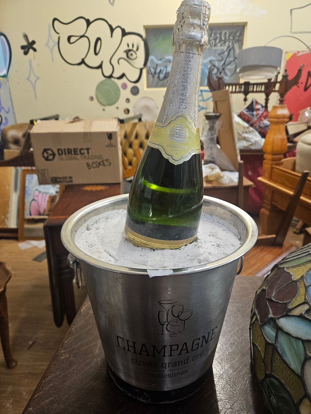 Lot 167 – A Stainless Steel Champagne Ice Bucket with Bottle
