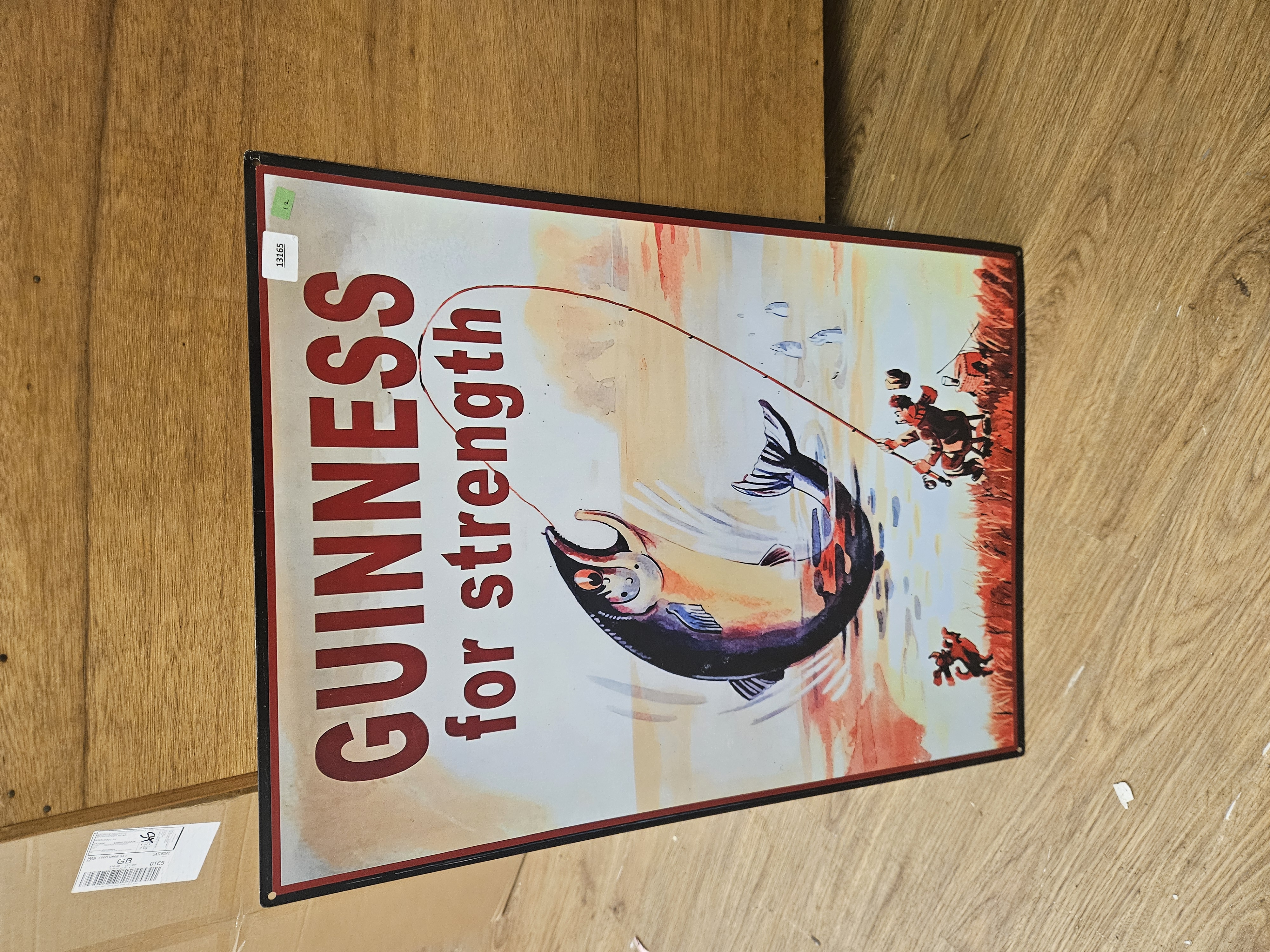 A reproduction metal Guinness for strength advertising sign