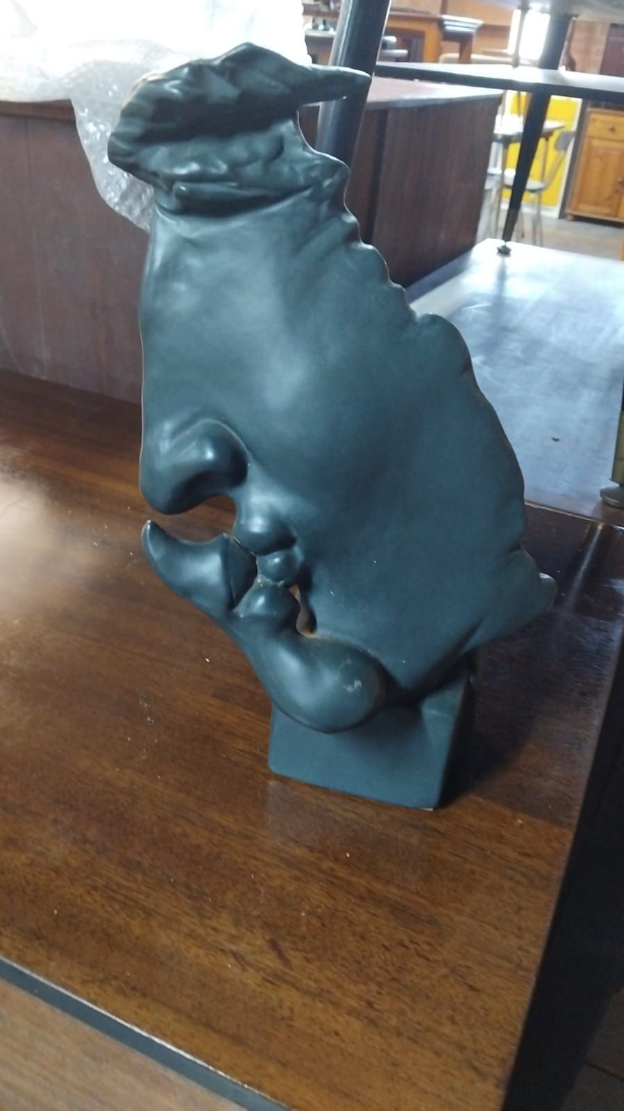 Lot 233 – A Modernist stylised dark grey composite sculpture depicting abstract kissing profiles