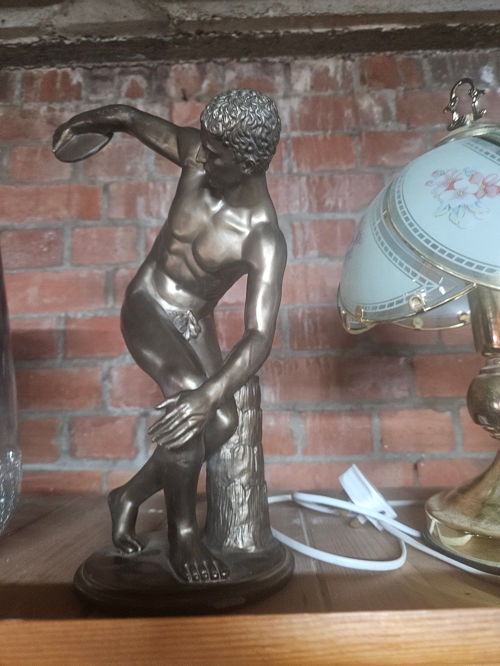 Lot 257 – A Bronze-patinated Sculpture of the Discobolus, after the Antique