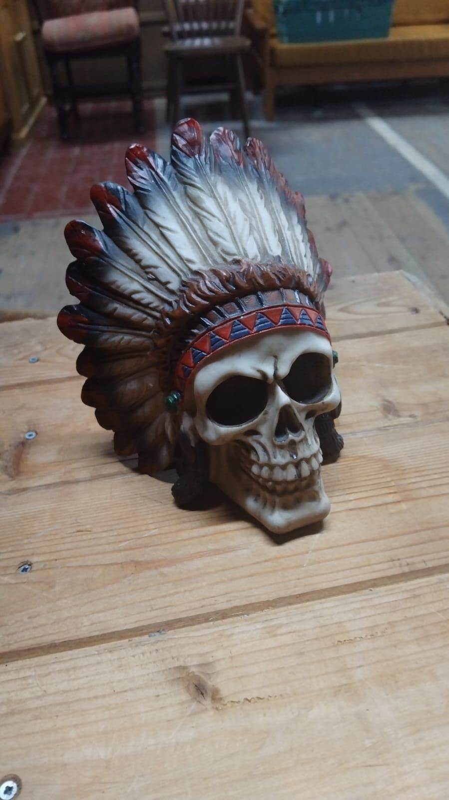 Lot 299 – A Contemporary Resin Skull Figure with Native American Style Feathered Headdress