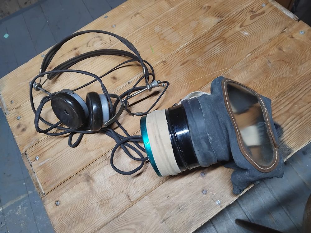 Lot 337 – Two Pieces of WWII Era German Military Equipment Comprising Communications Headphones and an Optical Mask Attachment