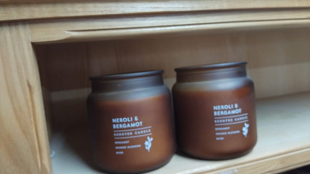 Lot 353 – A Pair of Neroli and Bergamot Scented Candles in Frosted Amber Glass Jars
