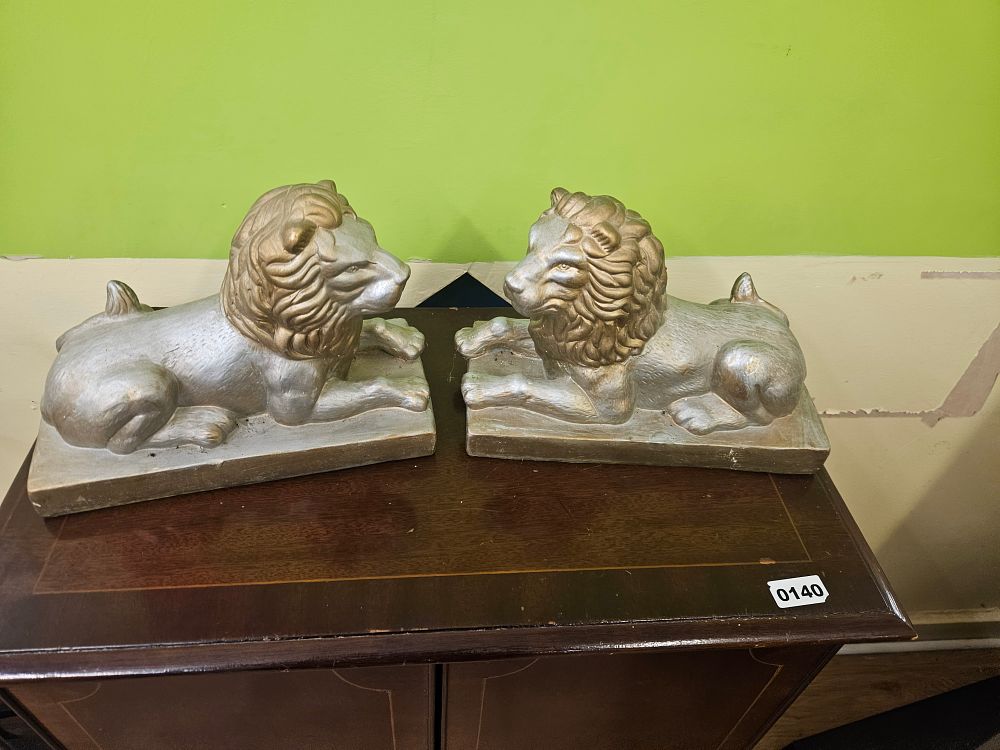 Lot 376 – A Pair of Decorative Cast Composition Recumbent Lion Sculptures