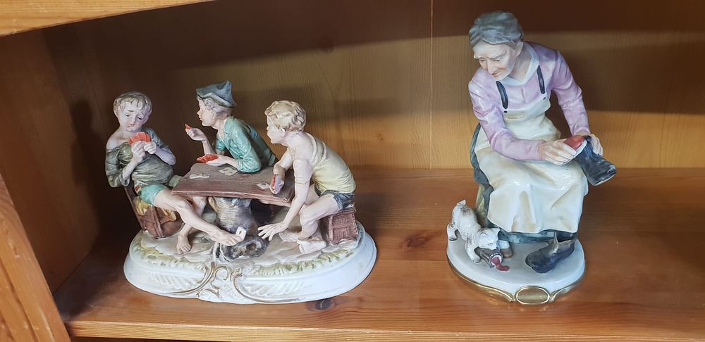 Lot 417 – A collection of four continental polychrome glazed porcelain genre figurines in the style of Capodimonte