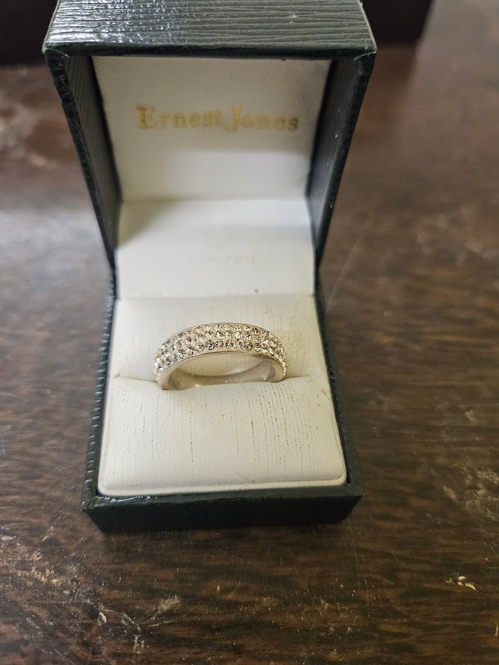 Lot 440 – A triple-row gem-set band ring in an Ernest Jones box