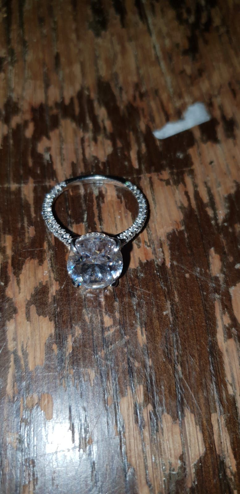Lot 500 – A 925 silver Solitaire Ring Featuring an Oval Cut Colourless Stone and Pavé Set Shoulders