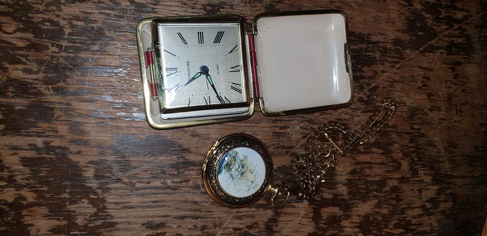 Lot 507 – Two items of horology comprising a Eurostar folding travel alarm clock and a decorative pocket watch with chain