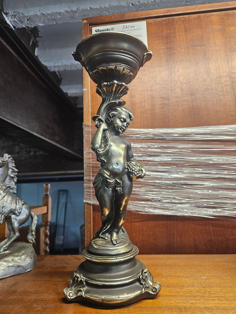 Lot 221 – A Late 19th or Early 20th Century Rococo Revival Cast Metal Figural Candlestick Depicting a Putto
