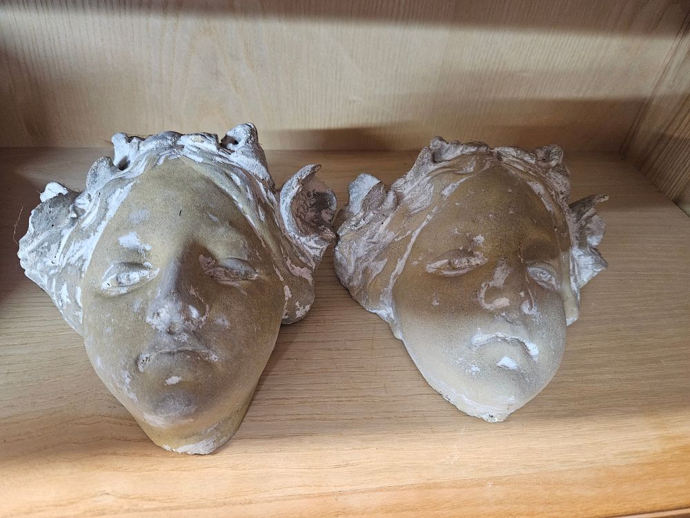 Lot 255 – A Pair of Weathered Cast Stone Neoclassical Style Wall Masks