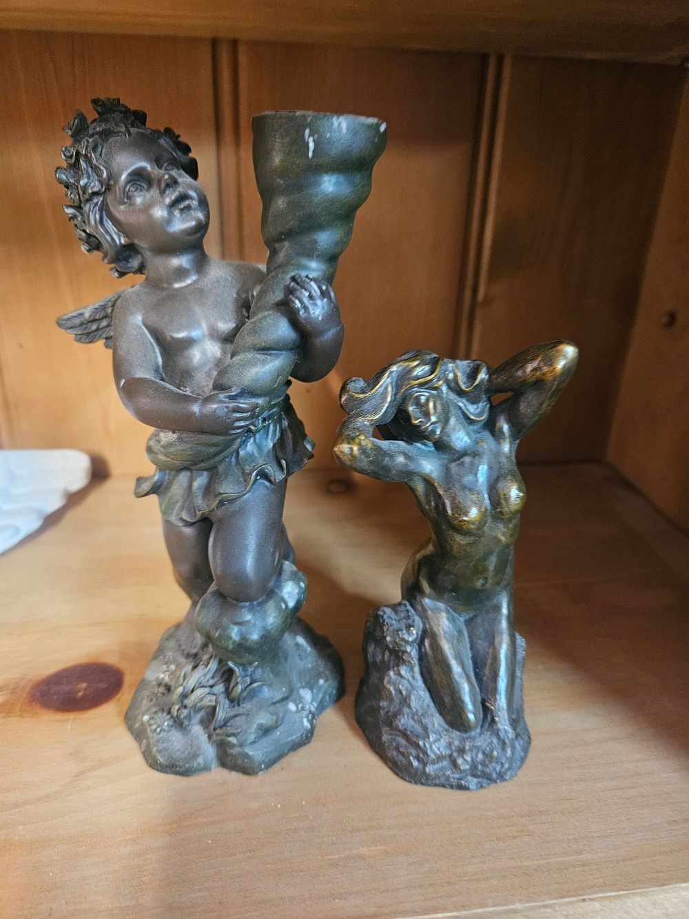 Lot 264 – A Pair of Patinated resin Figures of a Reclining Female Nude and a Winged Cherub