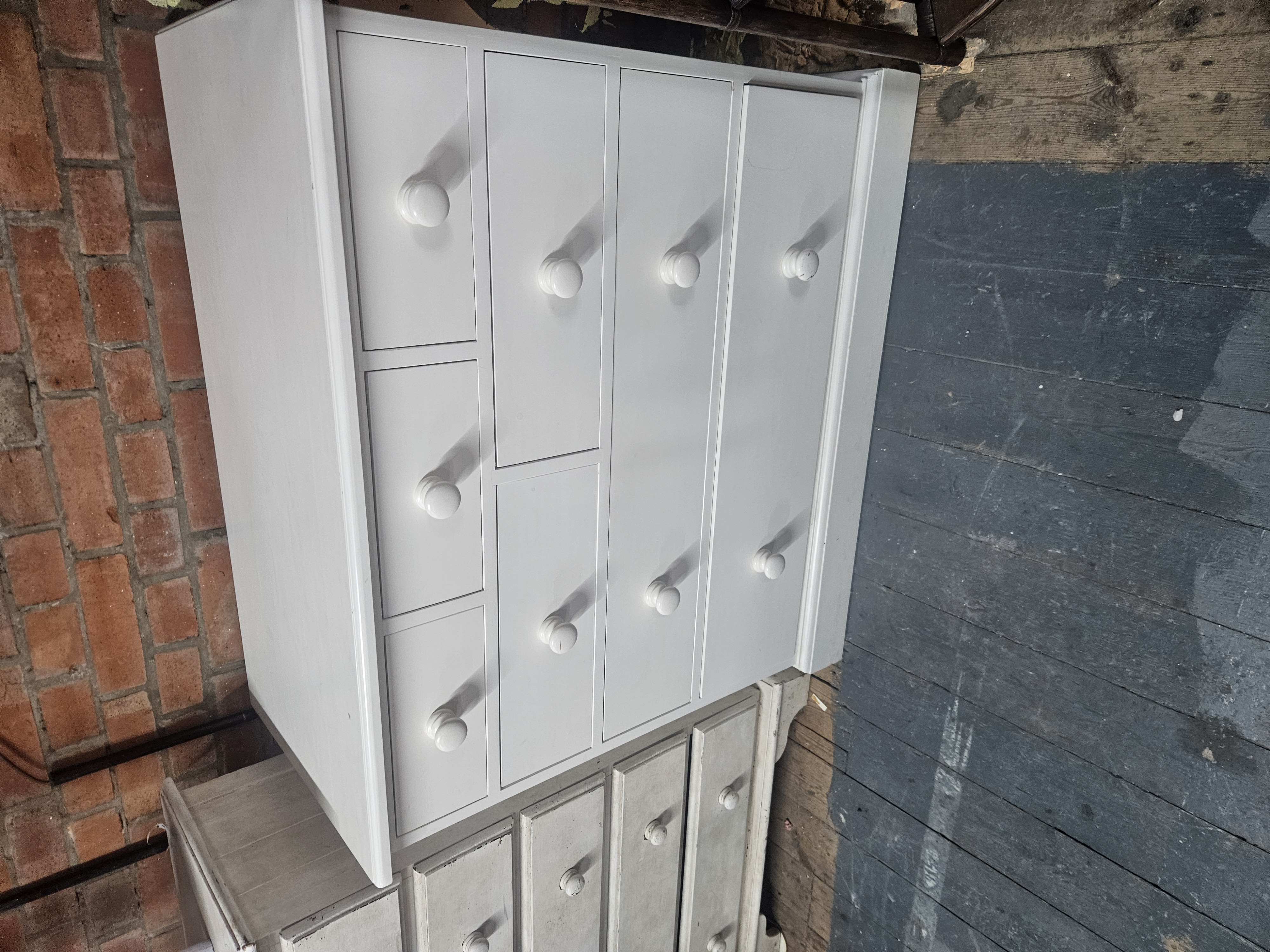 A Late Victorian Style White Painted Pine Nine Drawer Chest