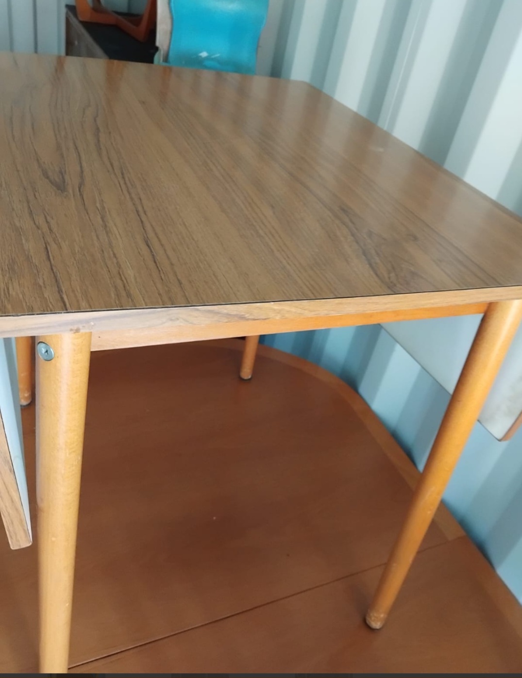 Mid-century modern drop-leaf dining table with teak-effect laminate top