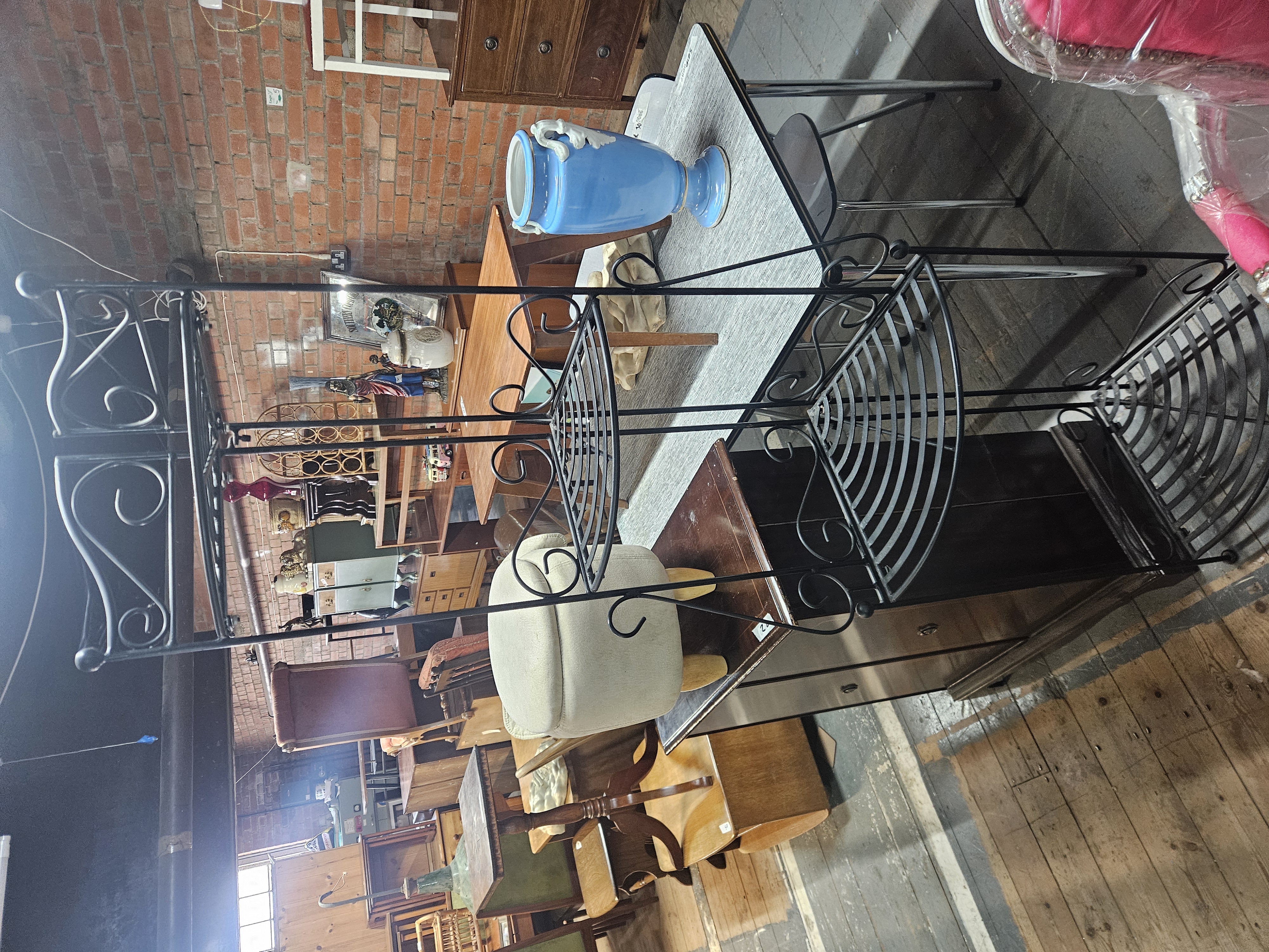 A Contemporary Black Painted Wrought Iron Four Tier Corner Etagere