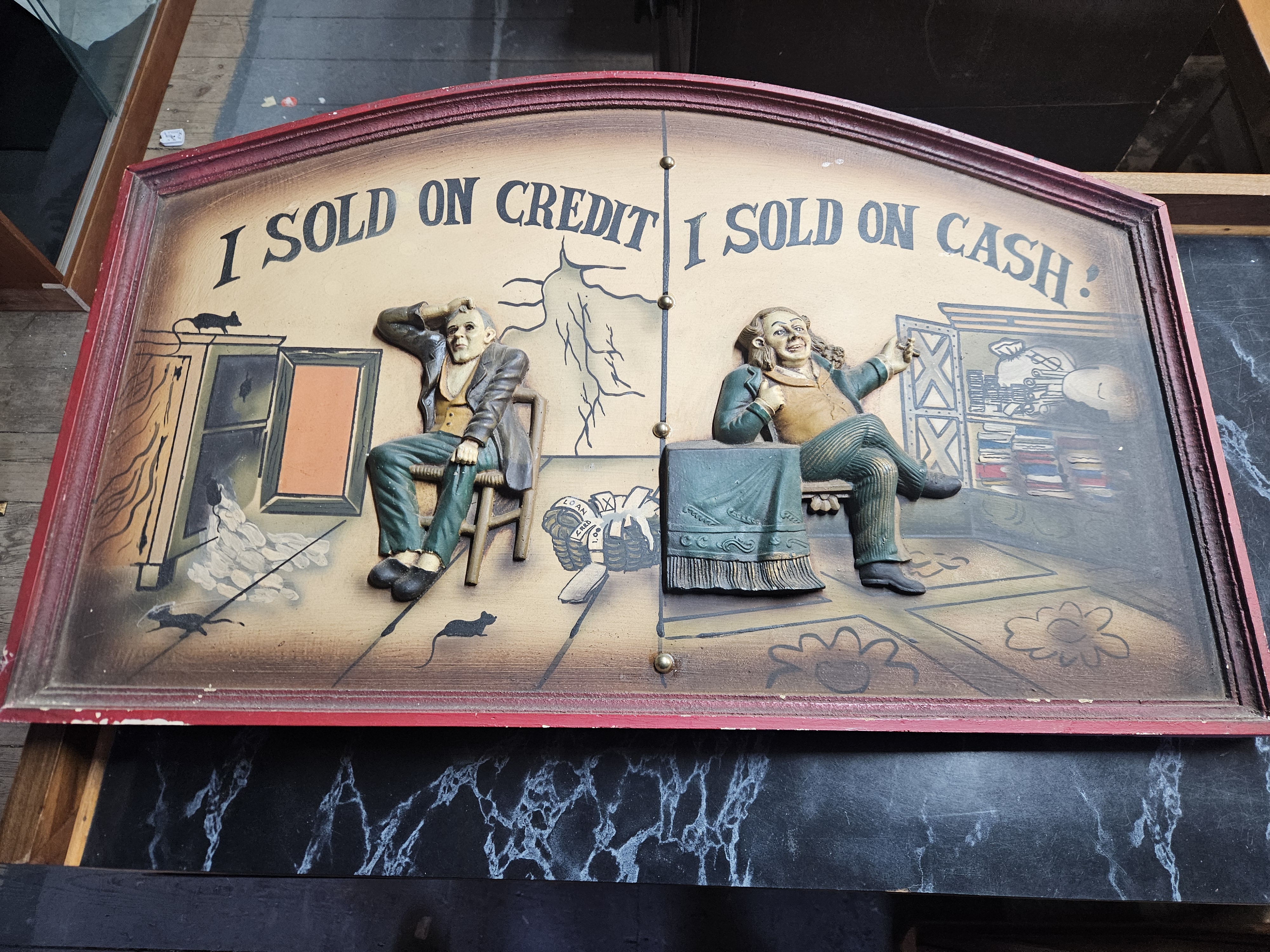 Mid-20th Century 3D Relief Painted Composition Advertising Plaque Depicting The Two Merchants