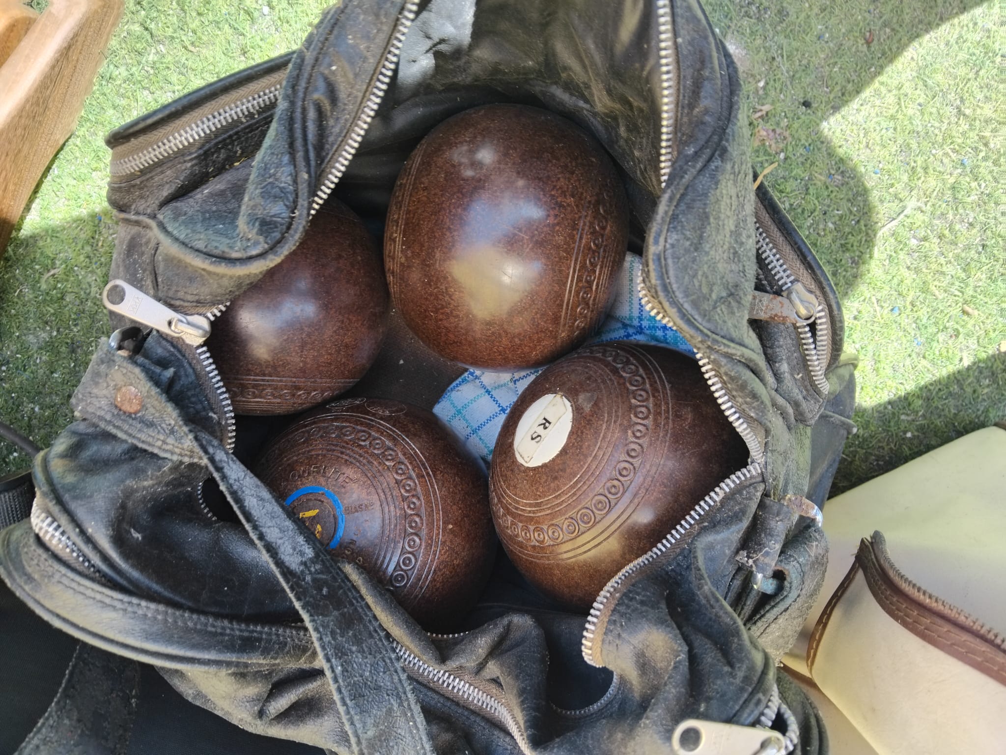A Set of Henslite Champion Lawn Bowls in a Carrying Bag
