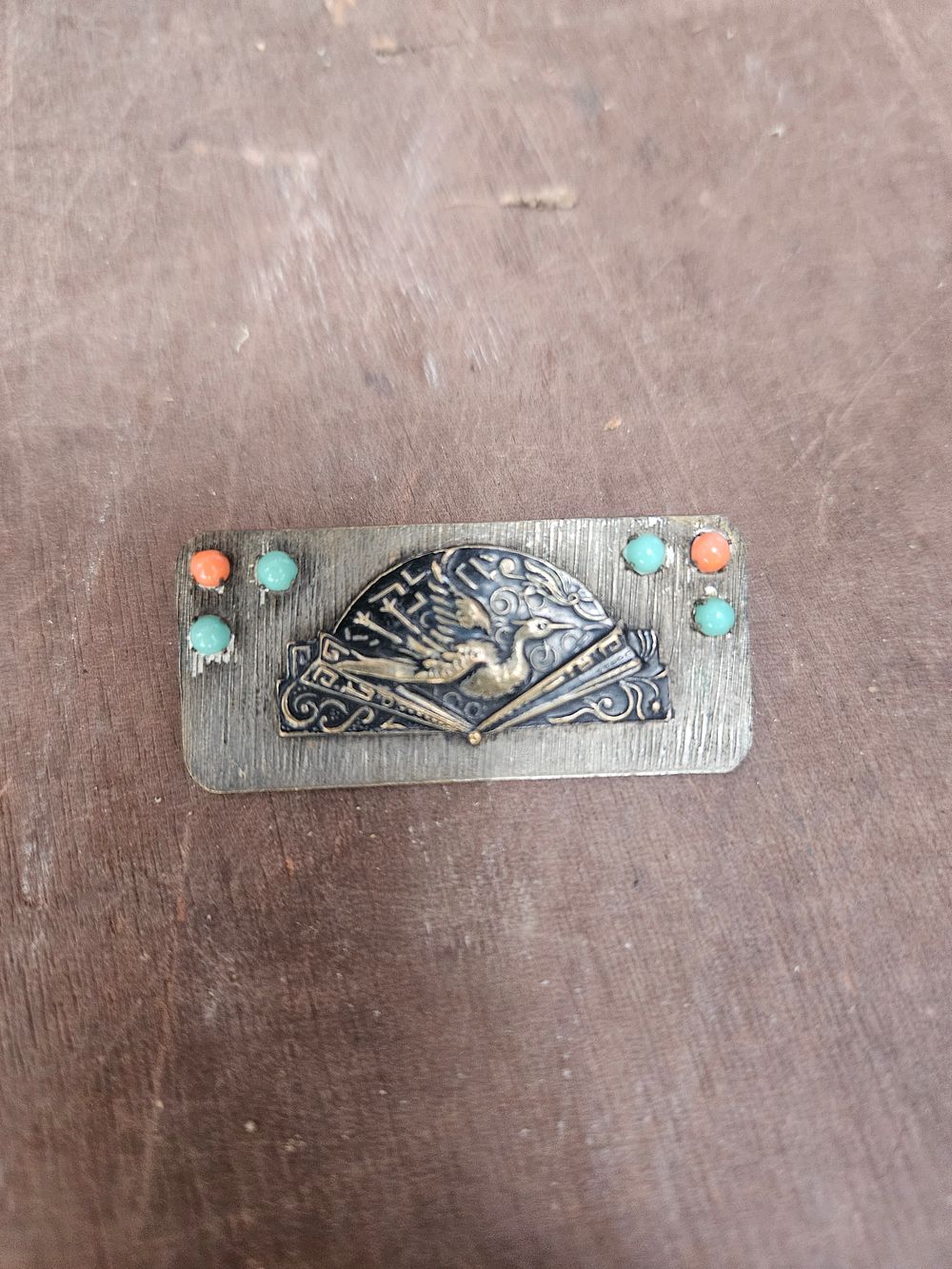 Lot 304b – Rectangular Mixed Metal Japonisme Brooch with Crane and Fan Motif