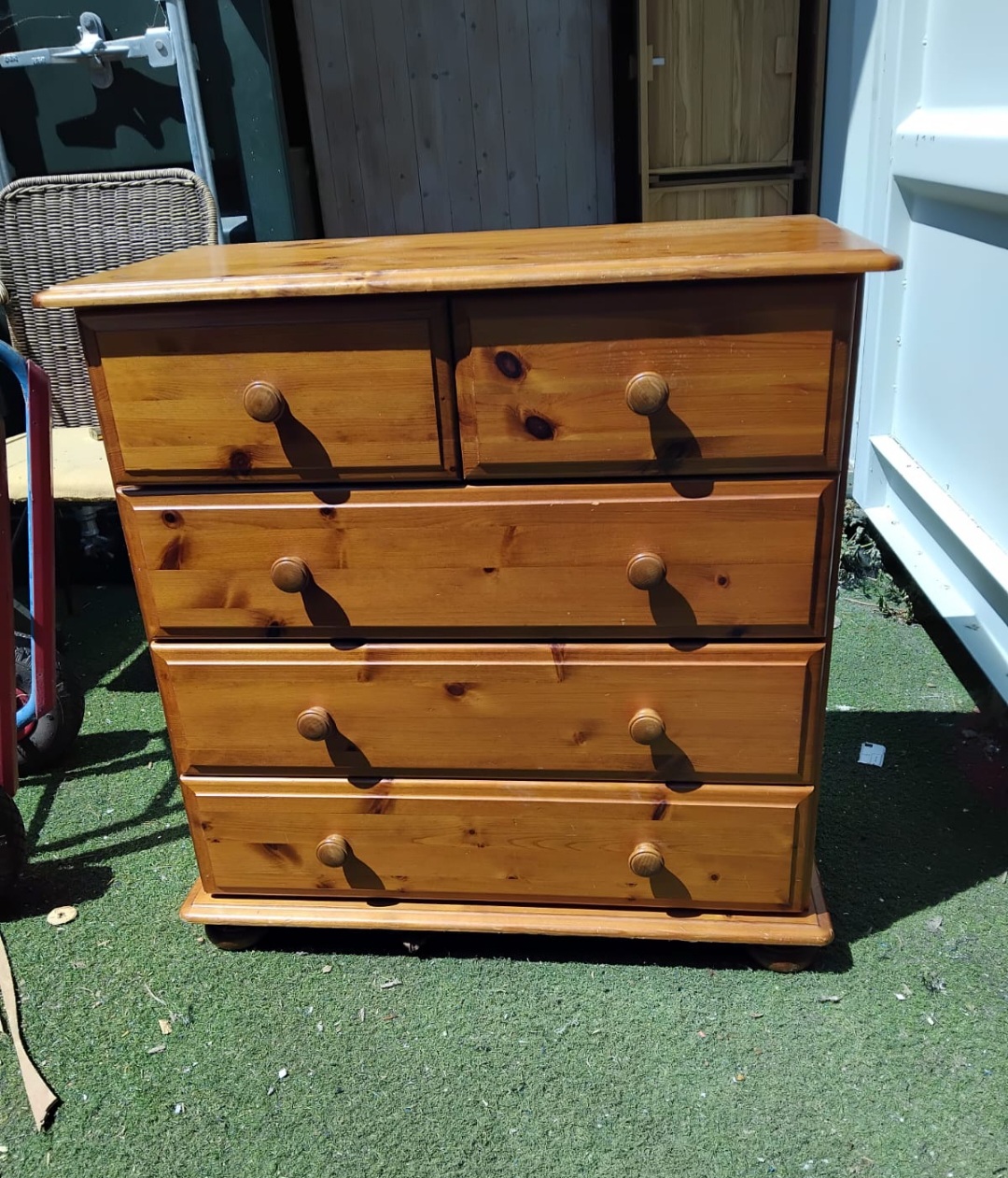 A contemporary solid pine two over three chest of drawers
