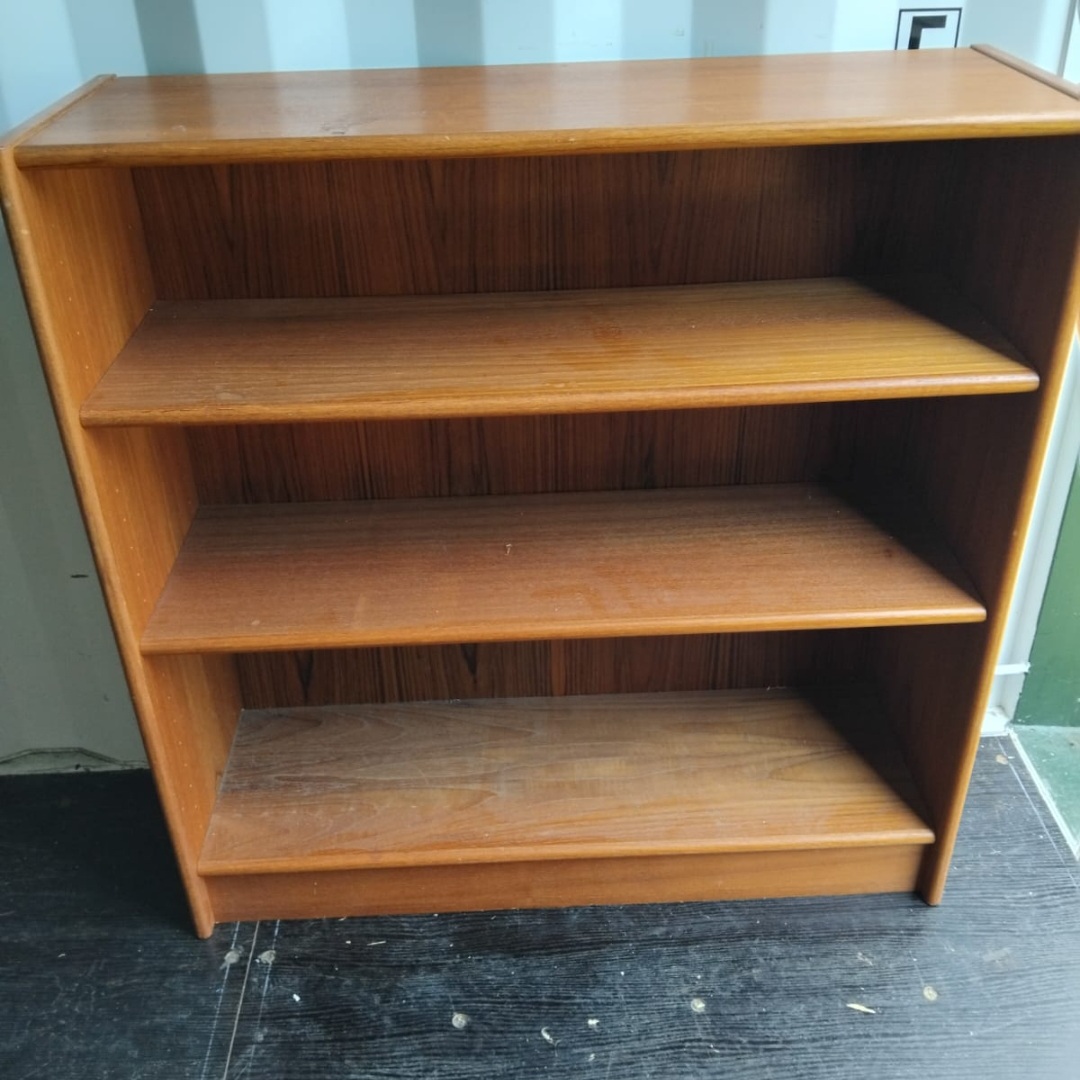 A mid-century modern teak-veneered low bookcase
