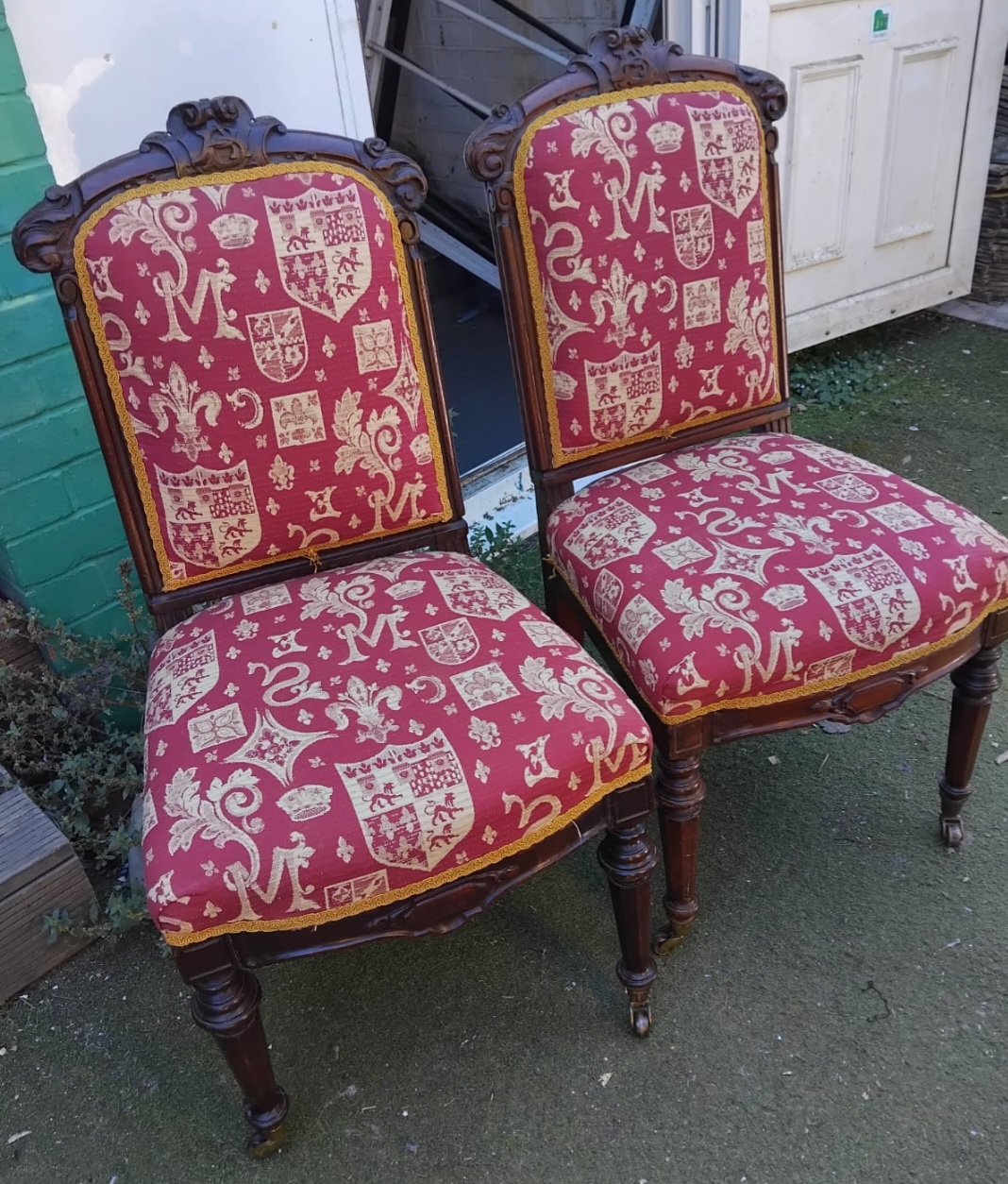 A Pair of Victorian Carved Oak Side Chairs with Heraldic Upholstery