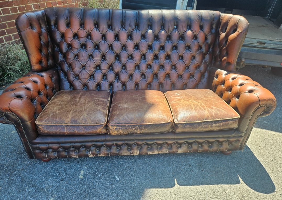 A Brown Leather Three Seater Wingback Chesterfield Sofa
