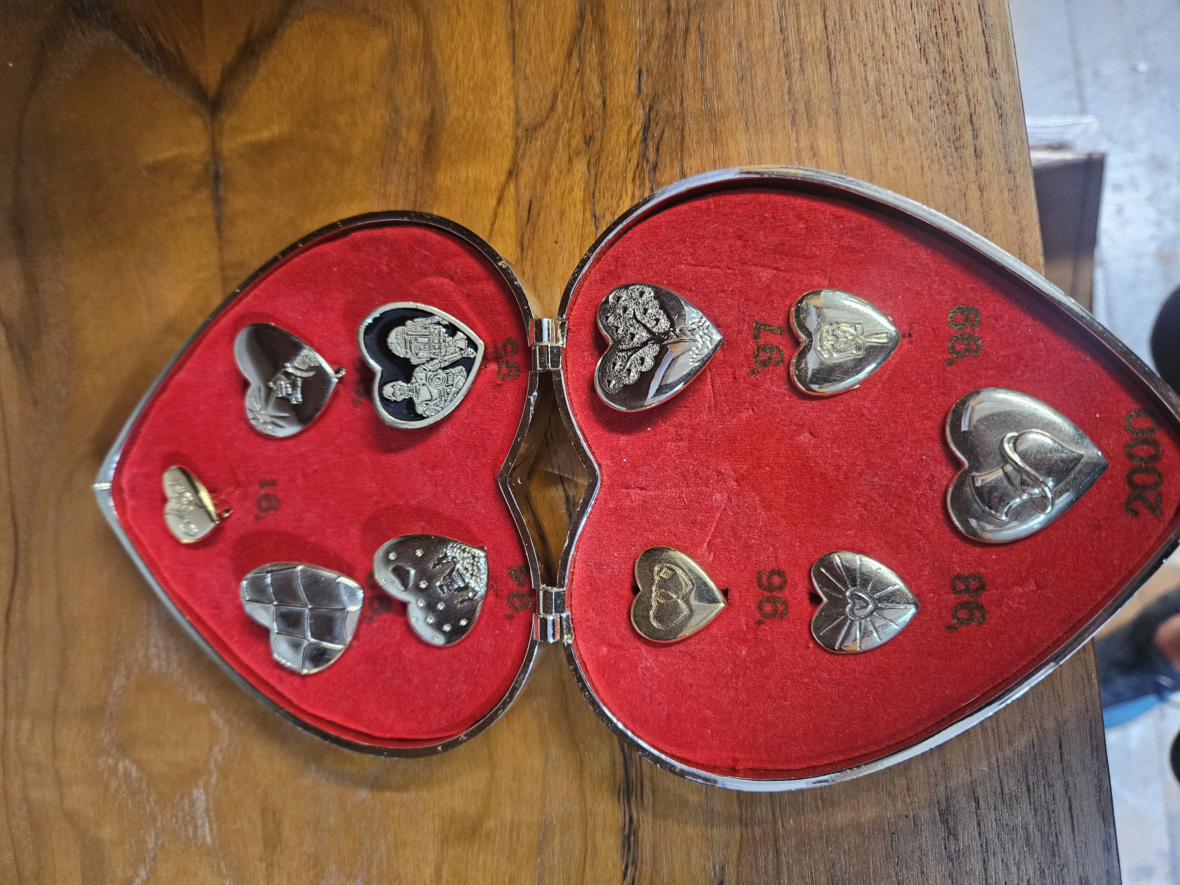 A Collection of Variety Club Gold Heart Day Commemorative Pins 1991 to 2000 in a Presentation Case