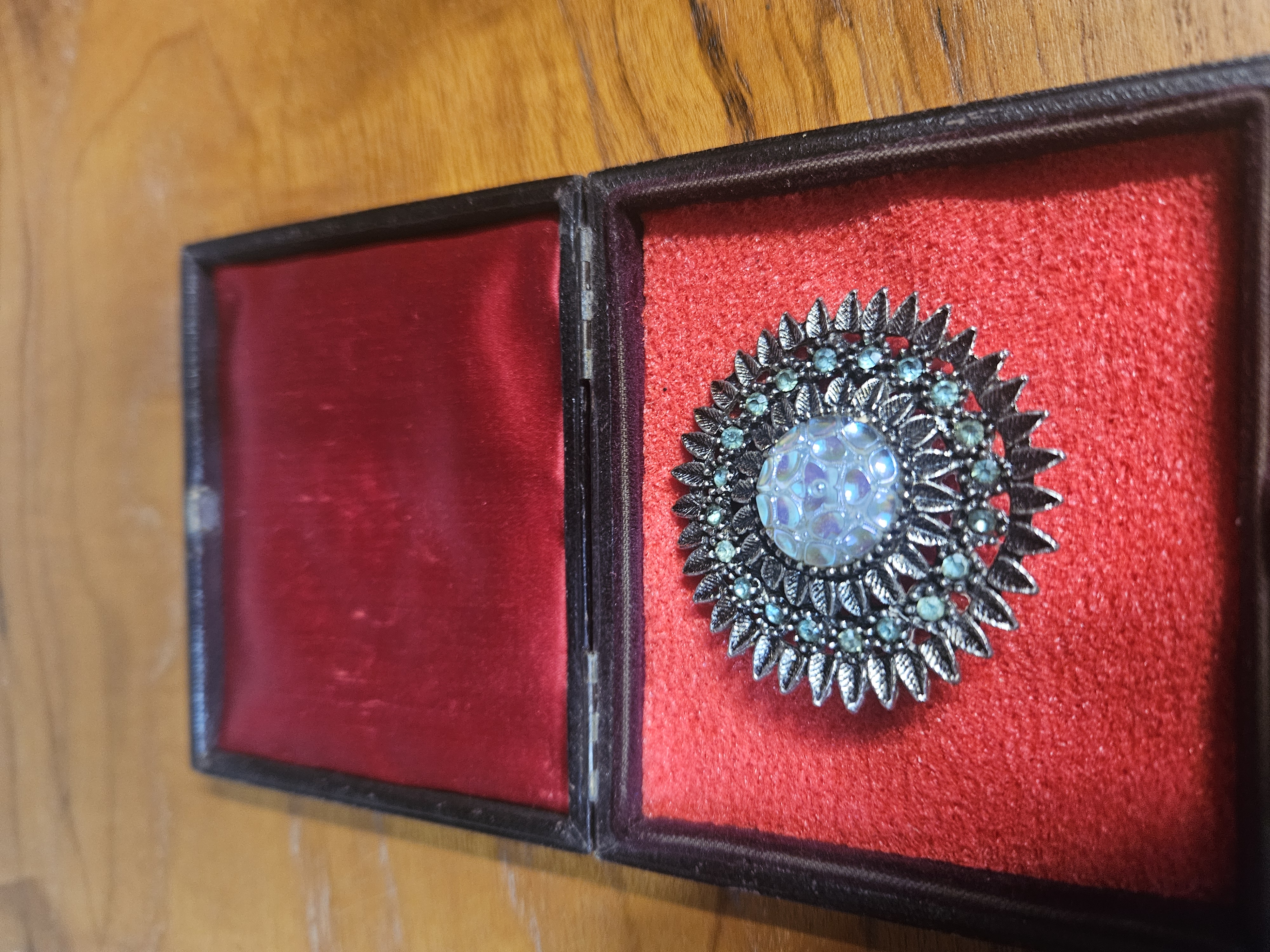A Vintage Silver-Toned Sunburst Brooch