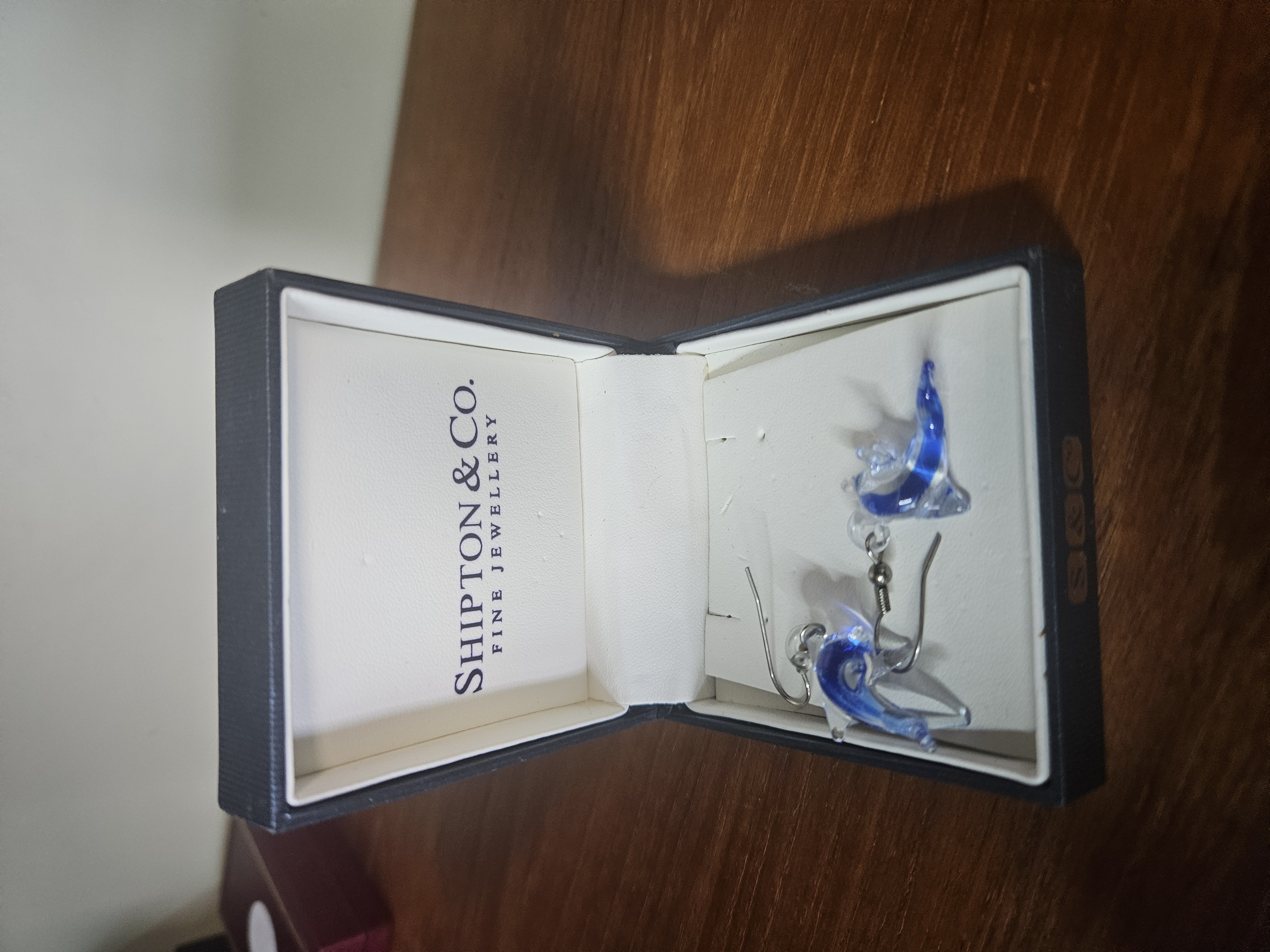 A Pair of Blue and Clear Glass Dolphin Drop Earrings
