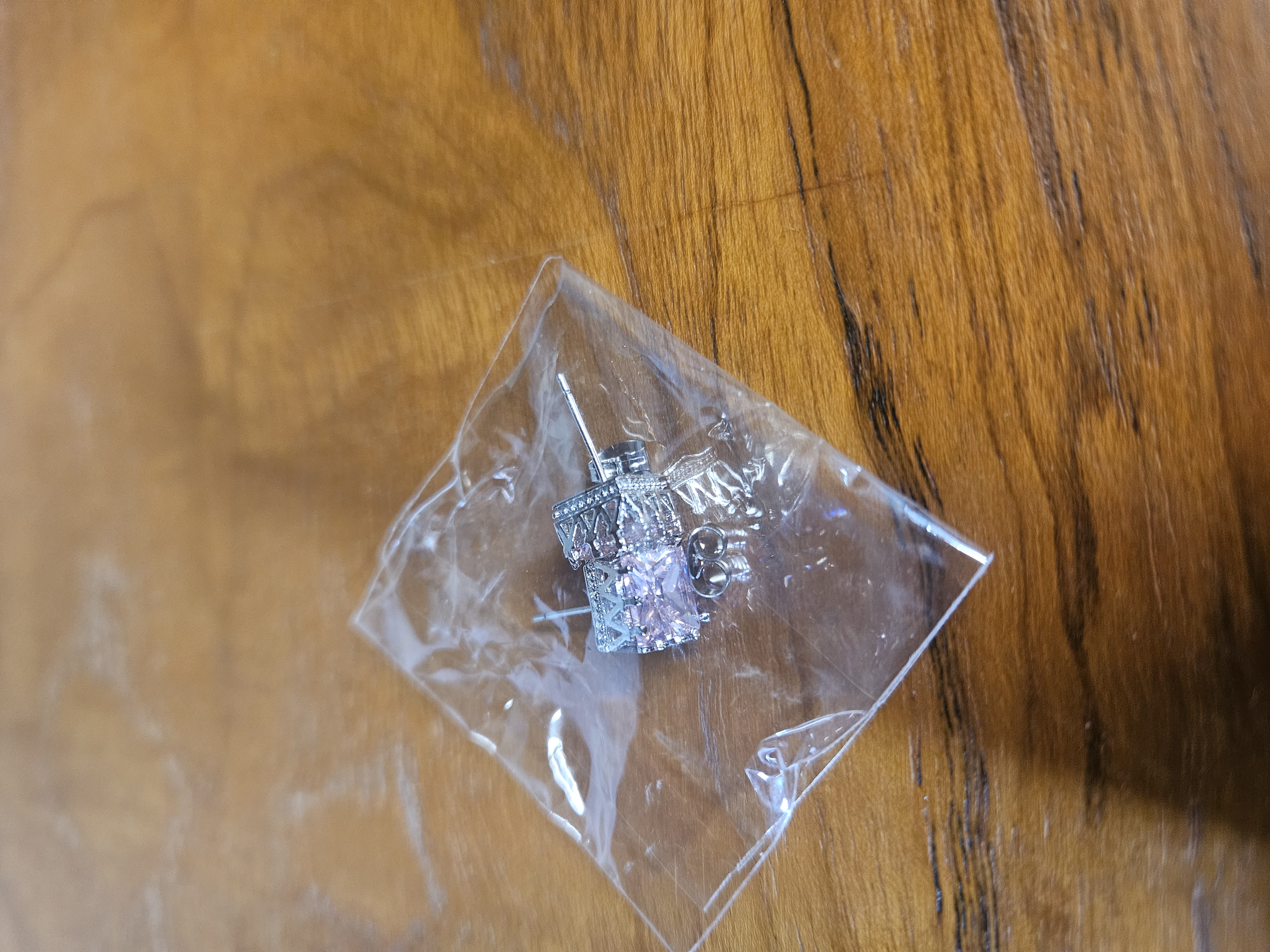 A Pair of Sterling Silver and Pink Cubic Zirconia Halo Stud Earrings