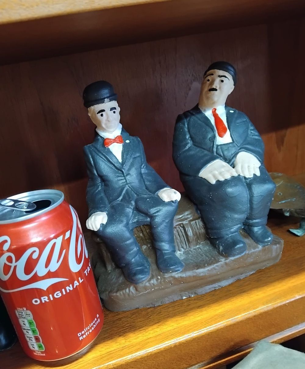 Lot 149 – A Painted Composition Figurine of Laurel and Hardy Seated on a Bench