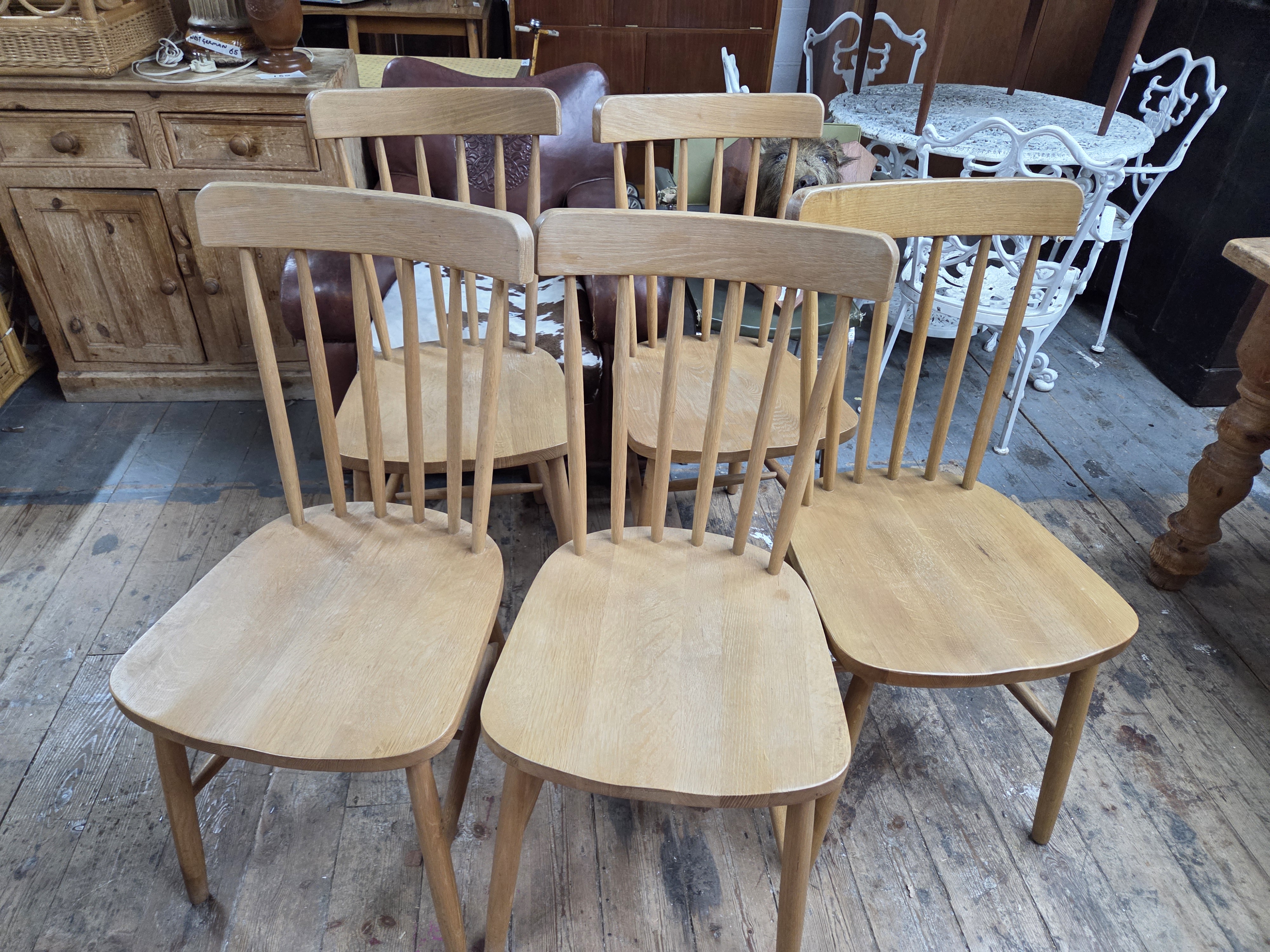A Set of Five Mid-Century Modern Wooden Spindle-Back Dining Chairs